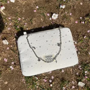 White star pattern laptop sleeve detail, featuring silver chain strap and sweet ballet style design.