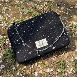 Black star print laptop sleeve with metal chain strap and cute charms for daily use.