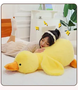 Cute yellow duck plush pillow detail showing soft fluffy fabric and cute sleeping duck design.