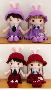 Detailed view of cute couple plush dolls with bunny ears hats and stylish skirts. Soft texture.