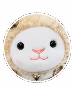 Cute lamb plush toy detail shot, soft fluffy fabric with delicate embroidered face and heart pendant.