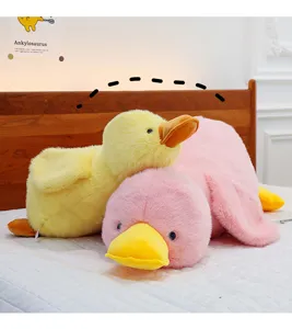 Cute fluffy lying duck plush pillow toy, soft stuffed animal doll for kids and home decor.