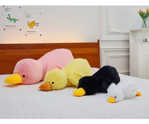 Cute plush lying duck pillow soft stuffed animal toy lovely sleeping doll companion for kids.