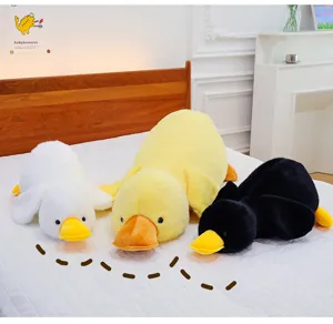 Cute lying duck plush pillow toy, soft stuffed animal doll for sleeping and room decor.