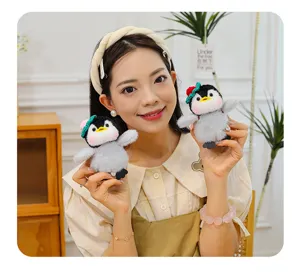Cute penguin plush keychain bag pendant with knitted hat, soft toy accessory for gifts.
