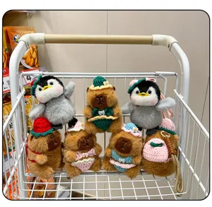 Knitted capybara and penguin plush keychain pendant detail showcasing cute crochet bikini designs.