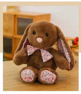 Cute brown plush bunny doll with floral ears and bow tie, soft companion toy for home decor.