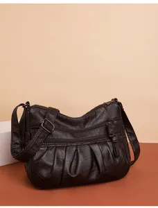 Detailed view of the dark brown soft leather multi-zipper shoulder crossbody bag.