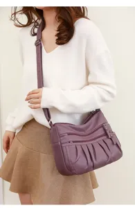 Women purple PU leather shoulder crossbody bag with multi-zipper pockets and adjustable strap.