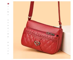 Detailed view of vintage soft leather cross-body bag with quilted design and heart lock.