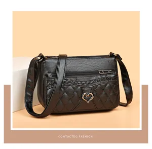 Retro black PU leather crossbody bag with chic quilted pattern and heart metal accent.