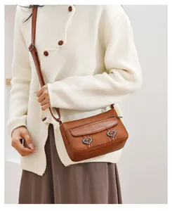 Retro brown soft leather crossbody bag with heart metal decor for women casual daily use detail