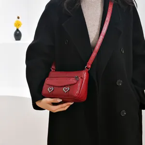 Red leather small crossbody bag vintage shoulder bag with heart charms and metal hardware.