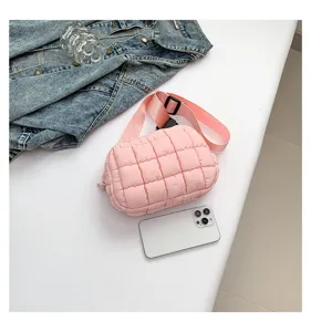 Pink quilted puffer crossbody bag detail showing soft texture and adjustable strap.