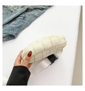 Quilted puffer fanny pack detail view, showing soft padded texture and buckle strap.