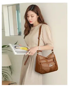 Detail view of multi-pocket soft leather shoulder bag with chic hardware and casual strap.