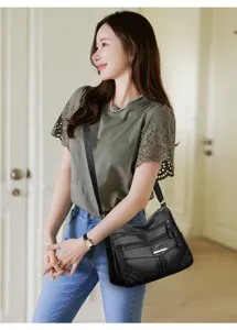Detailed view of women's soft leather multi-pocket shoulder bag, casual large capacity.