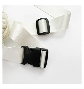 Adjustable white nylon bag strap detail with durable black plastic buckle and hardware.