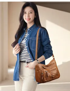 Borsa a tracolla vintage in pelle lavata con tasche multiple, dettagli fini e grande capacità.