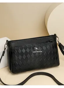 Detailed close-up view of black quilted leather shoulder bag, textured surface with logo.