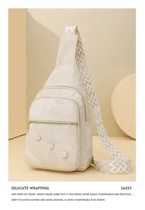 Casual beige sling backpack with wide patterned strap, double zipper and chic buttons.