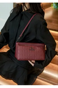 Stylish quilted shoulder bag for women, elegant wine red crossbody purse with metallic logo.