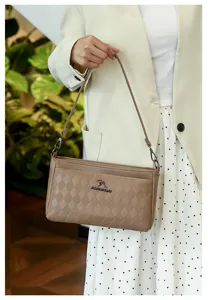 Close-up detail of the stylish quilted shoulder bag in light khaki, featuring fine diamond patterns.