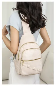 Casual sling chest bag for women, beige PU leather cross body backpack with zippers.