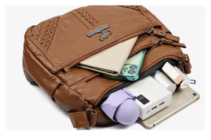 Detailed view of brown soft leather multi-pocket casual crossbody bag interior capacity showcase.