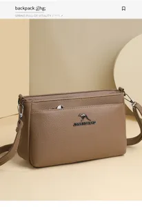 Close-up of stylish brown PU leather shoulder bag featuring metal logo and refined stitching.