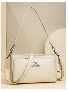 Detailed view of women soft leather shoulder crossbody bag in beige with metal accents.