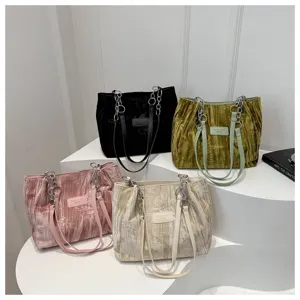 Detailed view of pleated velvet tote bags featuring chain handles and multi-color options.