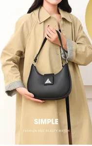Detailed view of women's black PU leather hobo shoulder bag with chic triangle metal clasp.