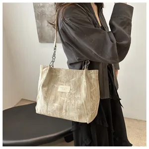 Detailed view of large capacity canvas shoulder tote bag with elegant bamboo print and chain.