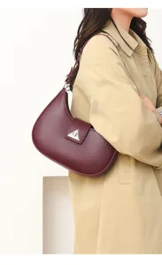Stylish women's crescent shoulder bag, minimalist PU leather underarm purse for spring daily wear.