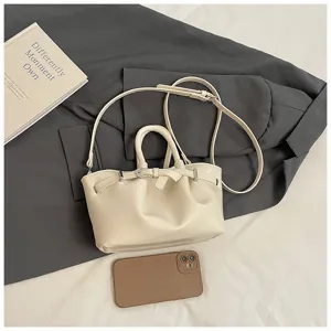 Chic solid color shoulder bag for women, stylish bucket design with top handle and strap.