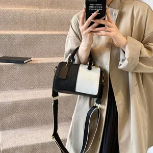 Chic black and white color block boston bag for women, versatile crossbody pillow handbag.