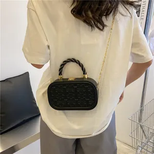Black crossbody box bag featuring elegant embossed clover patterns and stylish gold chain strap.