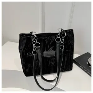 Black velvet tote bag with metal chain straps and front logo detail, casual chic shoulder bag.