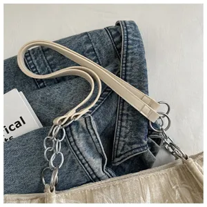 Close up view of the stylish chain and leather strap on the trendy shoulder bag detail.