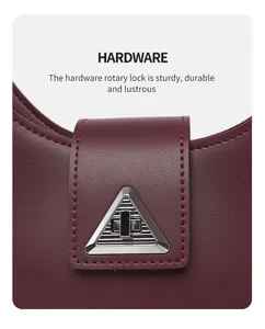 Close-up detail of stylish women handbag metal rotary lock, premium burgundy leather texture.