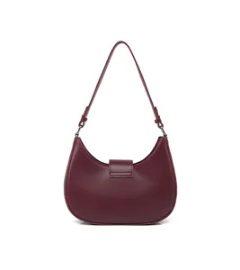 Close-up detail of the stylish burgundy crescent underarm shoulder bag with chic hardware.
