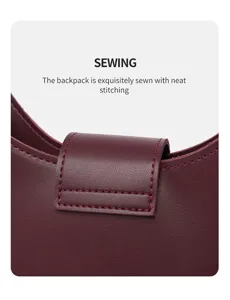 Detailed view of women's burgundy leather hobo bag featuring exquisite stitching and flap closure.