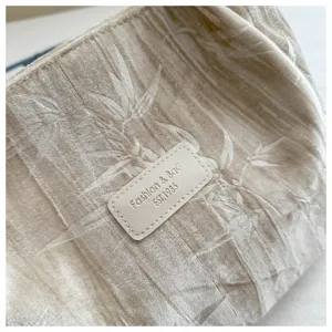 Detailed view of women velvet tote bag with elegant bamboo leaf texture and chic leather label.