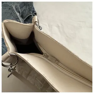 Women tote bag interior detail view showing zip closure and hardware rings, minimalist design.