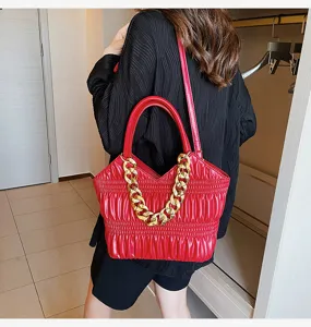 Red quilted shoulder bag with chunky gold chain detail, stylish women's handbag for daily wear.
