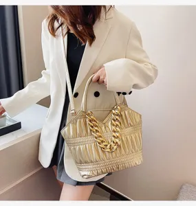 Golden metallic chain handbag, fashion shoulder messenger bag with textured design and chic.
