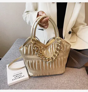 Metallic gold pleated handbag with chunky chain strap, elegant shoulder bag for women detail.