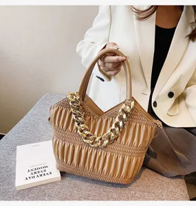 Ruched leather handbag for women, stylish brown shoulder bag with chunky gold chain strap.