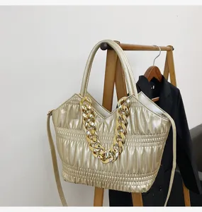 Metallic gold pleated handbag featuring a chunky chain accent, top handles and strap.